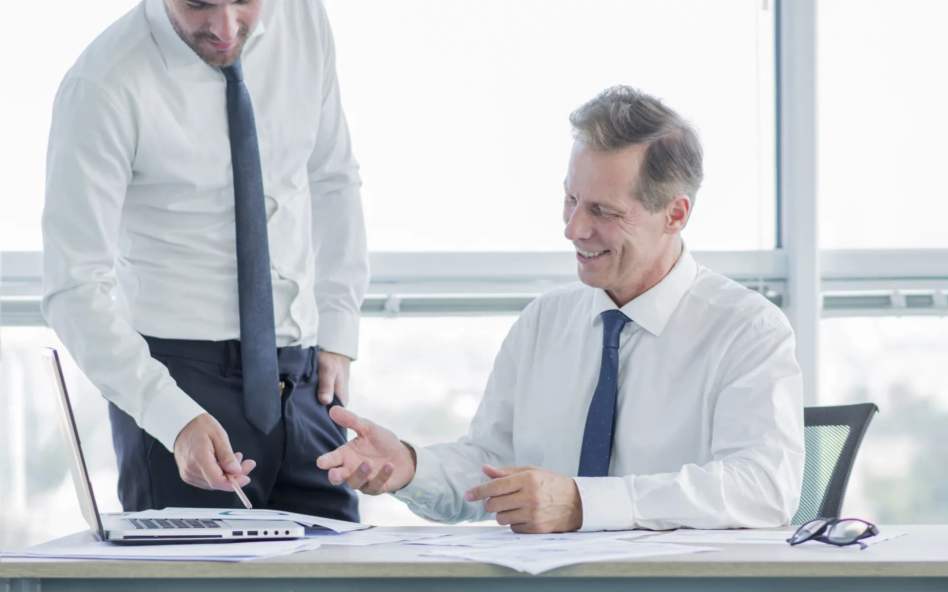 Two businesspeople reviewing documents together in an office