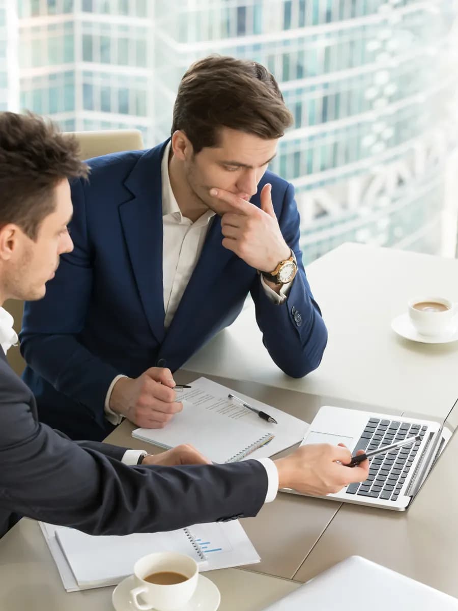 Business advisers reviewing documents together in a bright office
