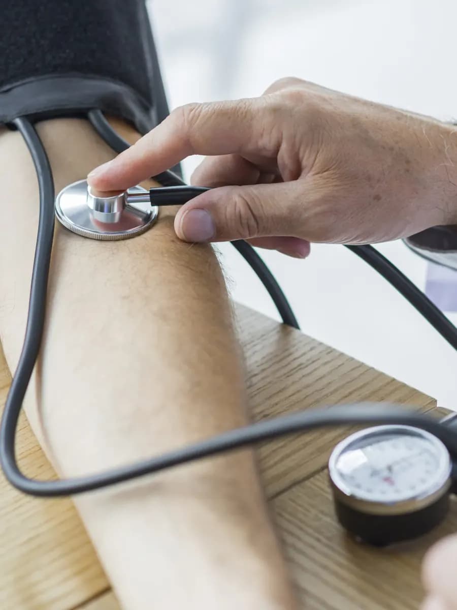 Medical professional checking a patient’s blood pressure