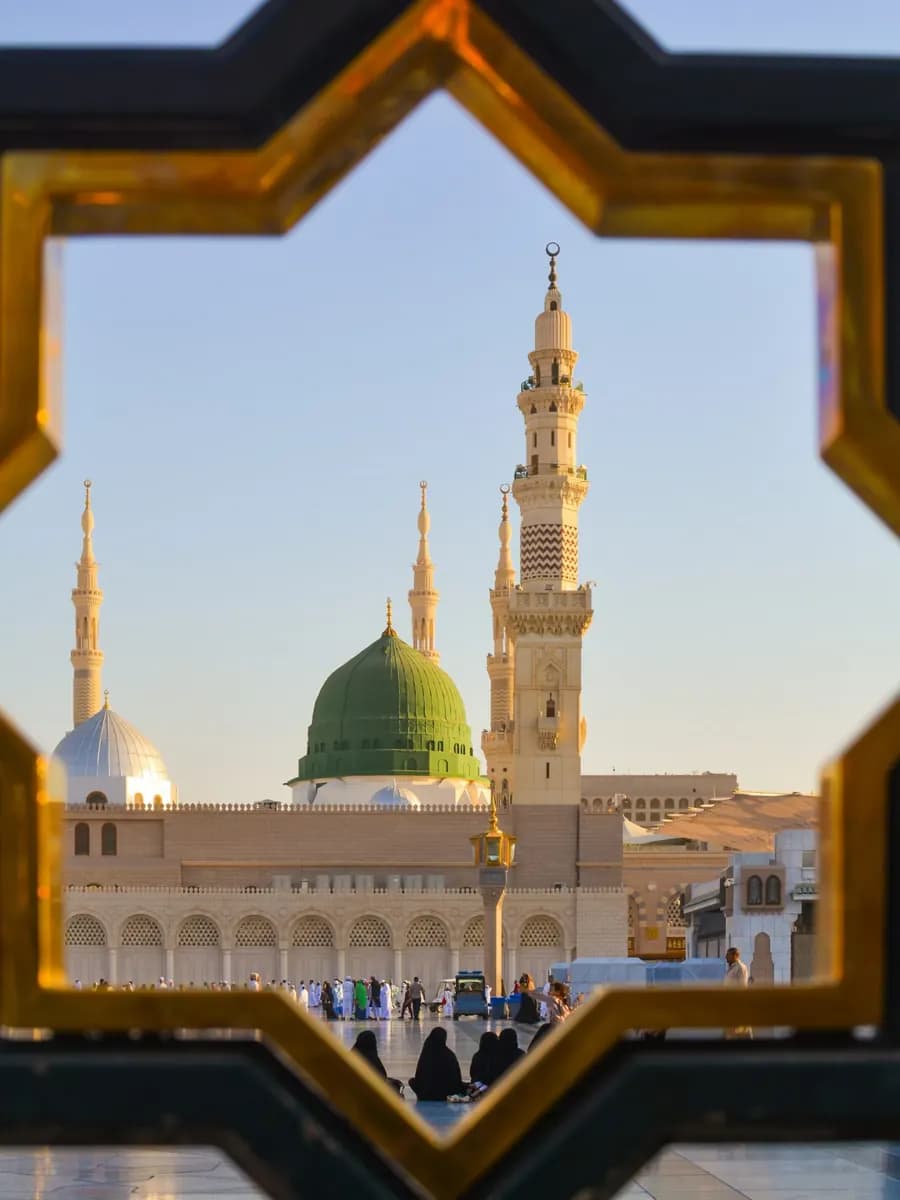 View of a mosque framed by an Islamic geometric arch